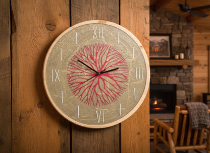 Round wall clock with red coral design hung  on mountain cabin wall
